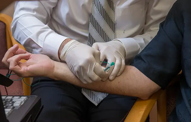 Dr. Martinez uses an electronic guiding system to give a patient a nerve-specific injection in the lower arm.