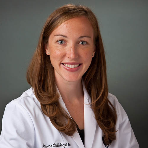 Jessica Vollebregt headshot. She wears a white lab coat
